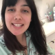 From under the toilet, a very cute girl pushes out a log that hangs and drops, followed by the product. Filmed from a between the legs perspective. Vertical format video. About a minute.
